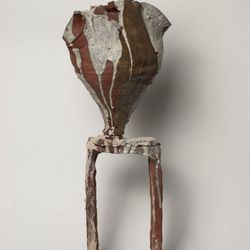 Dark sandy vase on the stage